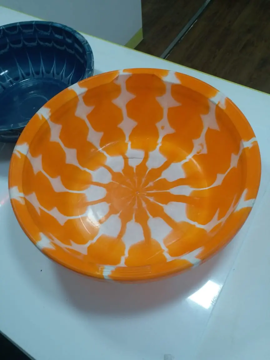 Orange and white flower pattern plastic bowl from a double colour injection moulding attachment
